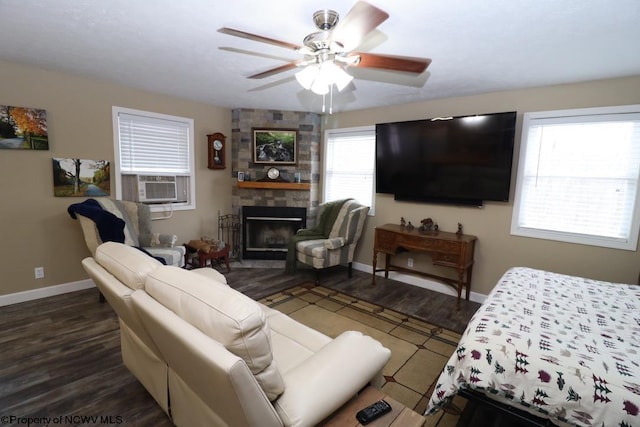 bedroom with cooling unit, dark wood-type flooring, a fireplace, and ceiling fan