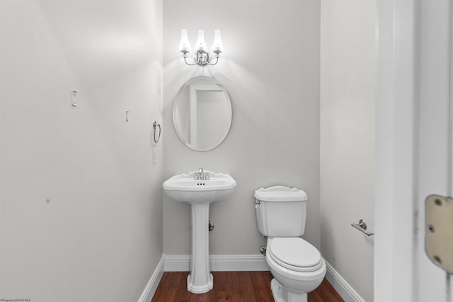 bathroom with sink, hardwood / wood-style flooring, and toilet