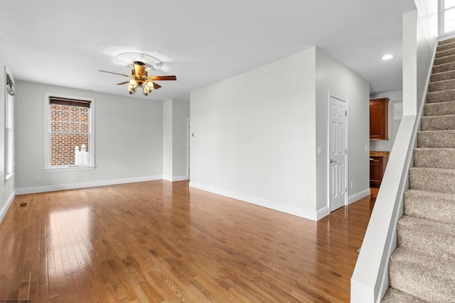 empty room with ceiling fan and hardwood / wood-style floors