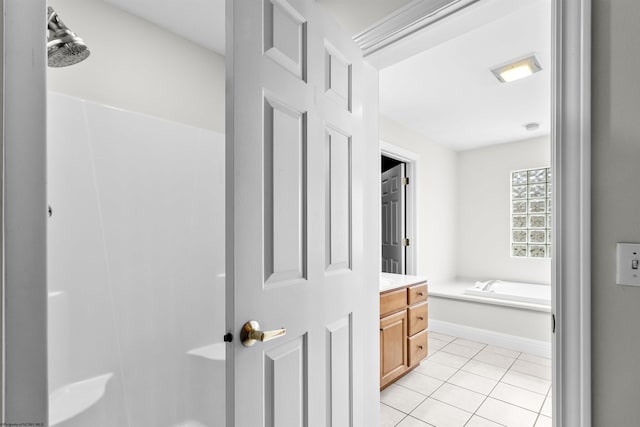 bathroom featuring a washtub, vanity, and tile patterned floors