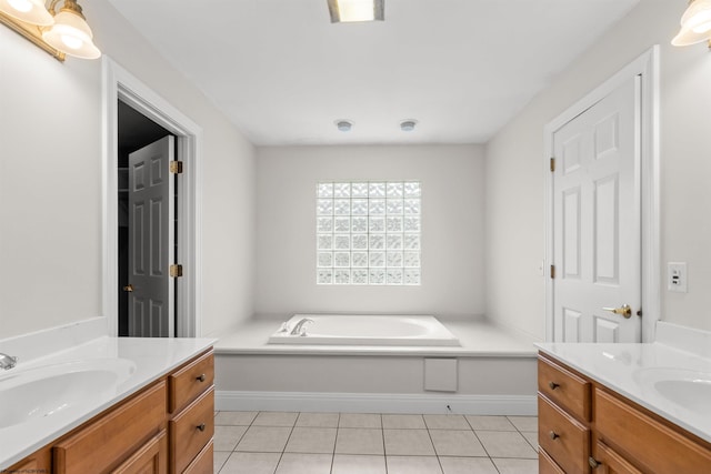 bathroom featuring vanity, tile patterned floors, and a tub to relax in