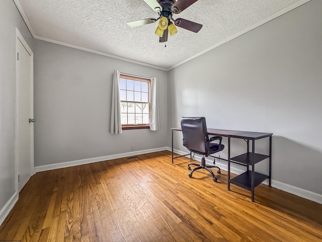 office space with wood-type flooring, ceiling fan, a textured ceiling, and crown molding