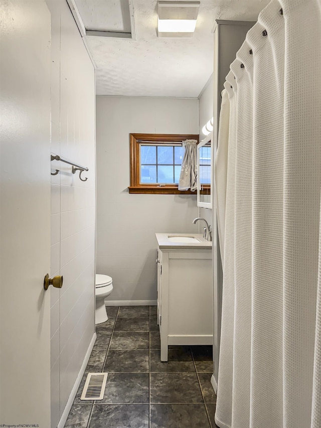 bathroom featuring vanity and toilet