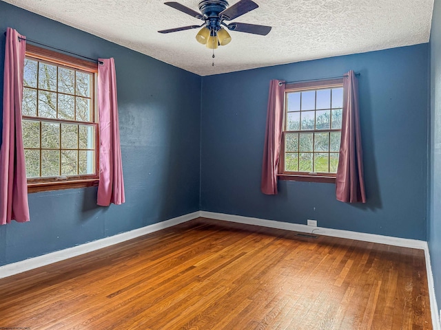 unfurnished room featuring hardwood / wood-style floors, a textured ceiling, and ceiling fan