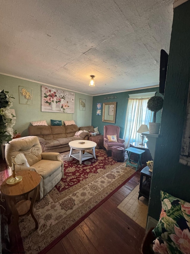 living room featuring hardwood / wood-style flooring, crown molding, and a textured ceiling