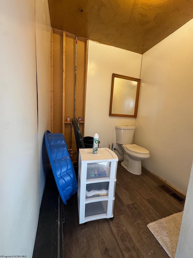 bathroom featuring wood-type flooring and toilet