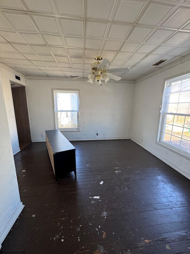 unfurnished dining area featuring dark hardwood / wood-style floors and ceiling fan