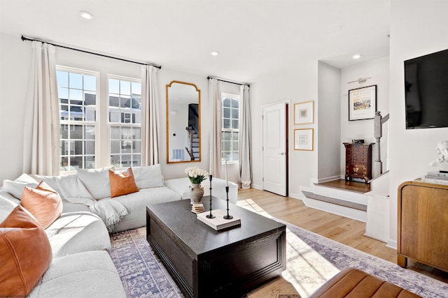 living room with a healthy amount of sunlight and light hardwood / wood-style floors