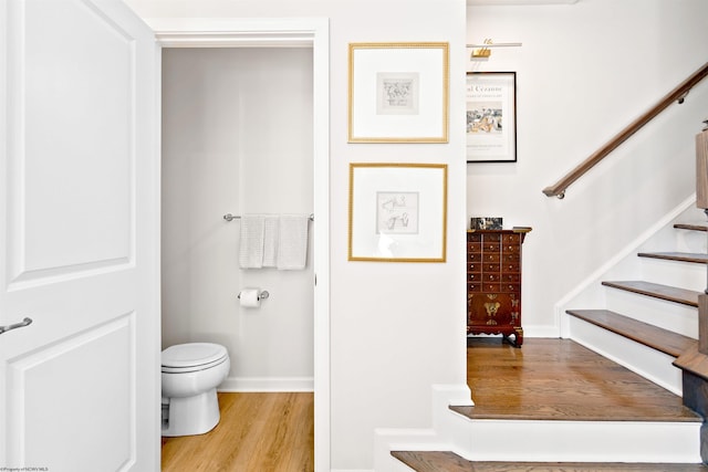 bathroom featuring wood-type flooring and toilet