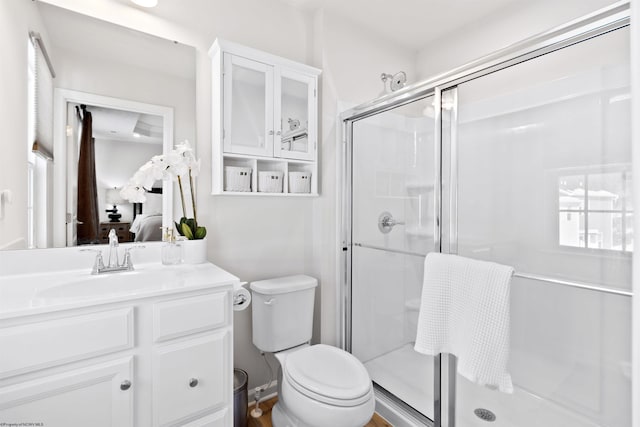 bathroom featuring an enclosed shower, vanity, and toilet