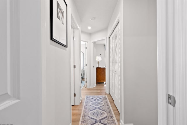 corridor with light hardwood / wood-style floors