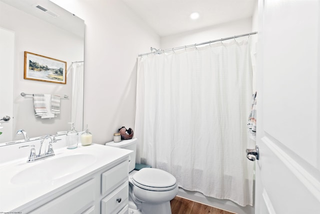 full bathroom with vanity, wood-type flooring, shower / bath combo, and toilet