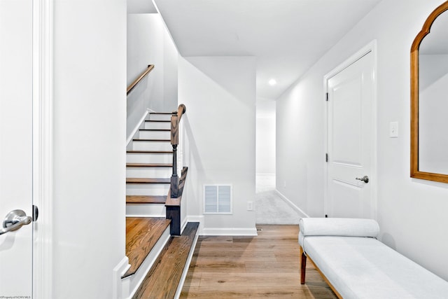 staircase featuring hardwood / wood-style floors