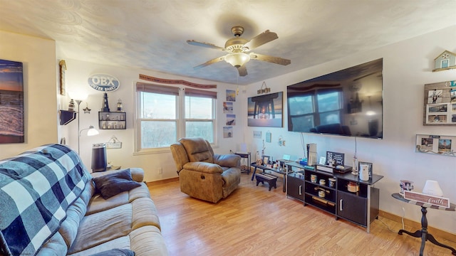 living room with ceiling fan and light hardwood / wood-style flooring