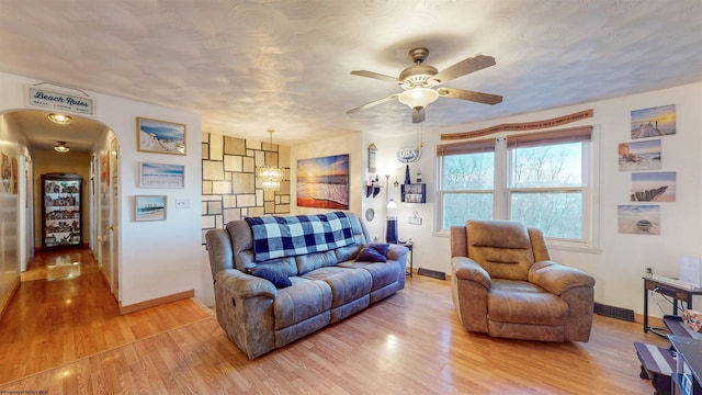 living room featuring hardwood / wood-style floors and ceiling fan