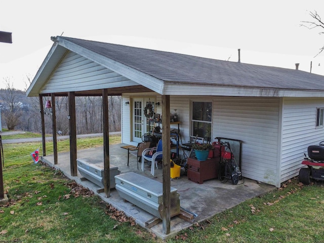 rear view of property with a patio and a lawn