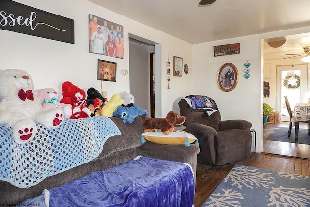 living room with dark hardwood / wood-style floors and ceiling fan