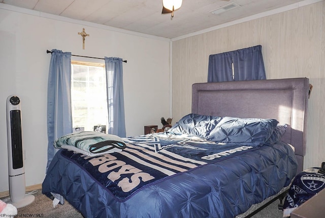 carpeted bedroom featuring crown molding and ceiling fan