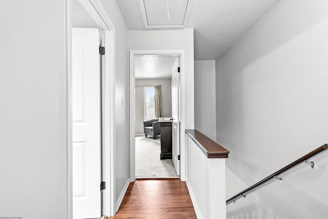 corridor with dark wood-type flooring and a textured ceiling