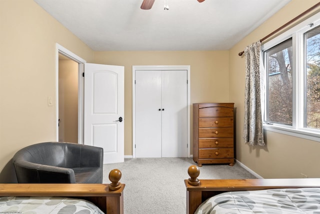 carpeted bedroom featuring a closet and ceiling fan