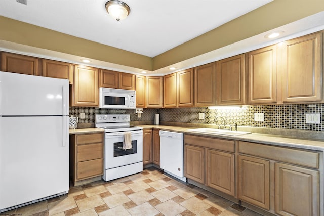 kitchen with white appliances, sink, and backsplash