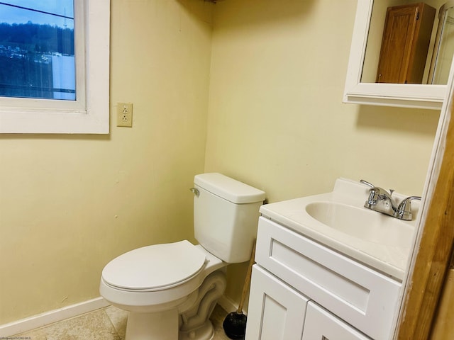 bathroom with vanity, tile patterned flooring, and toilet