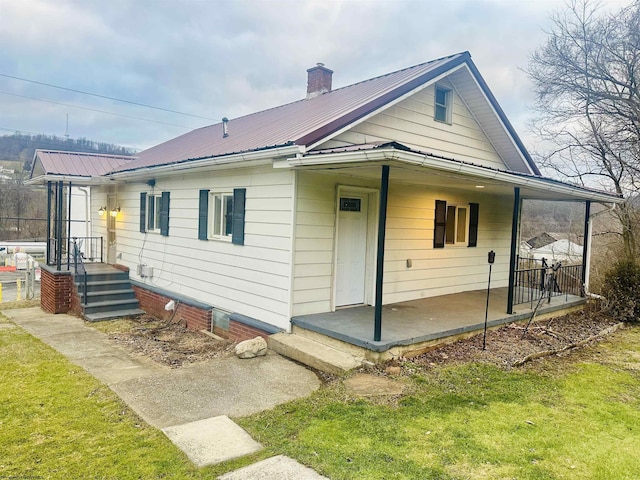 rear view of property featuring a yard