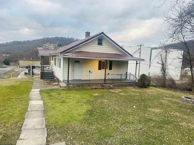 view of front of house featuring covered porch and a front lawn