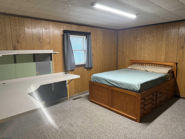 unfurnished bedroom with light carpet, wood walls, and visible vents