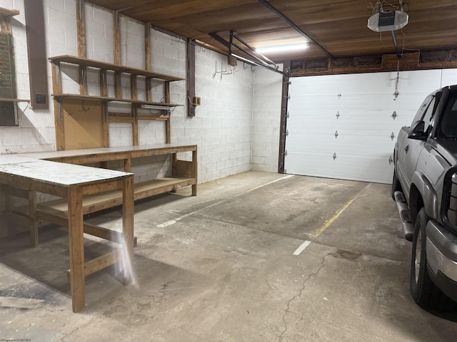 parking deck featuring a garage door opener and concrete block wall