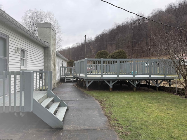 exterior space featuring a yard and a wooden deck