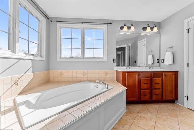 bathroom featuring vanity, tiled bath, and tile patterned floors