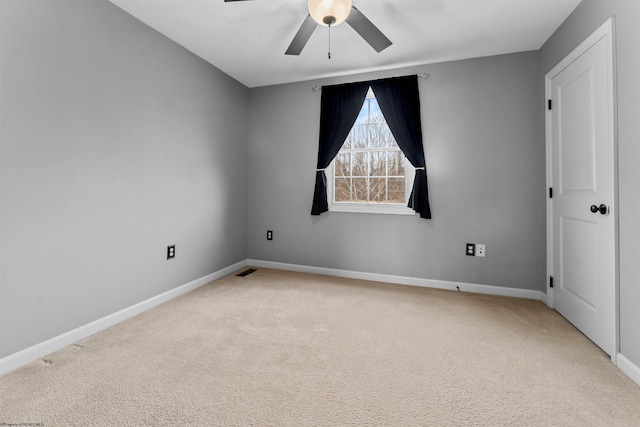 carpeted spare room featuring ceiling fan