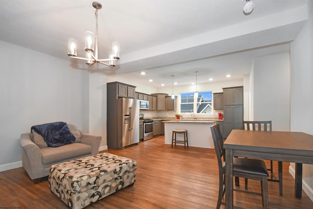 interior space featuring a notable chandelier, sink, and light wood-type flooring