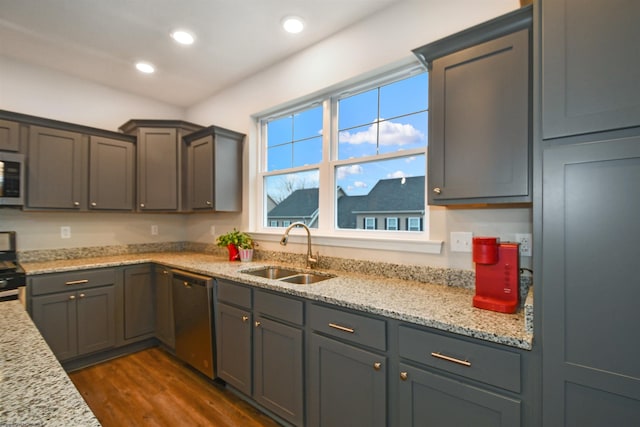 kitchen with sink, light stone counters, range, stainless steel dishwasher, and dark hardwood / wood-style floors