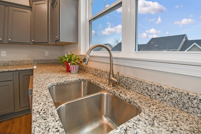 interior details with sink and light stone countertops