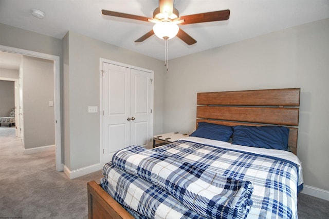 bedroom with carpet, ceiling fan, and a closet