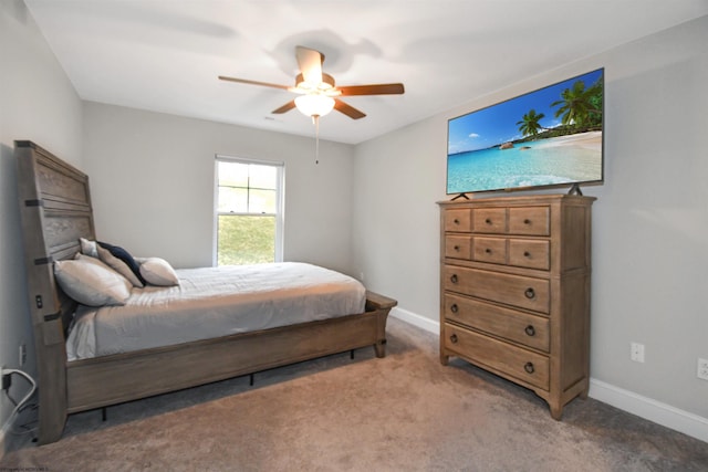 bedroom with ceiling fan and dark colored carpet