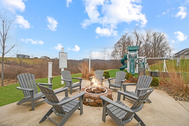 view of patio / terrace featuring a playground and a fire pit