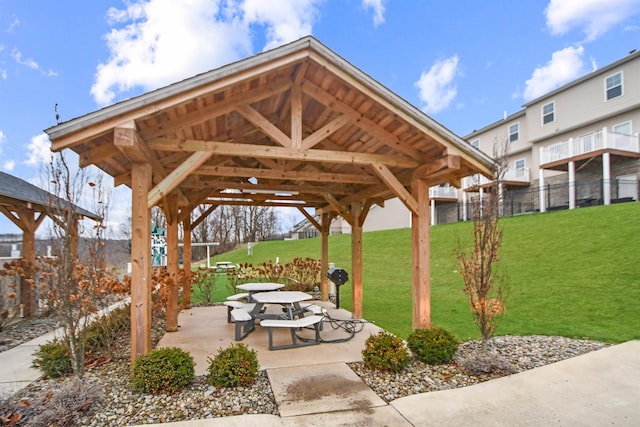 view of property's community with a gazebo, a yard, and a patio area