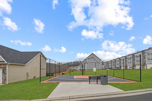 surrounding community featuring basketball court and a lawn