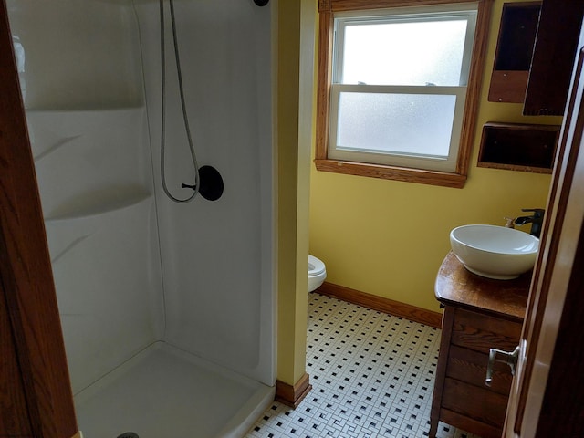 bathroom featuring vanity, toilet, and walk in shower