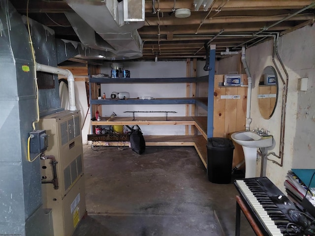 basement featuring sink and heating unit