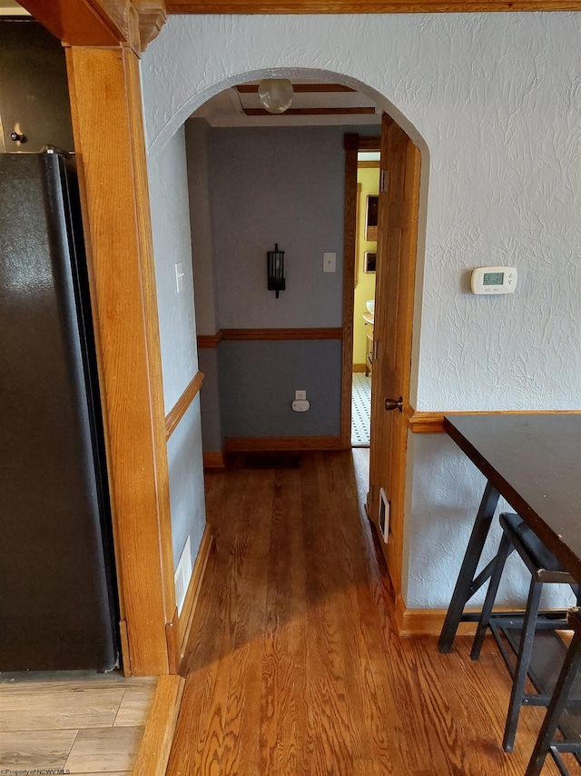 corridor with hardwood / wood-style floors