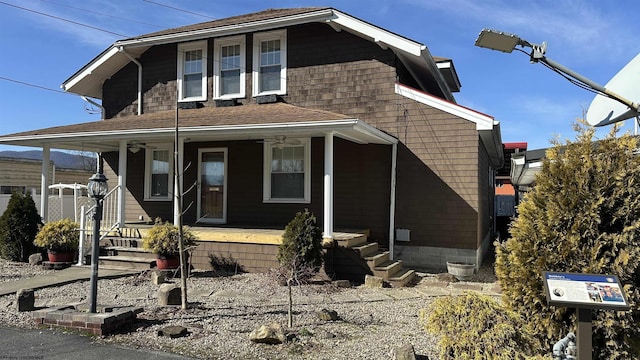 view of front of property featuring ceiling fan and covered porch