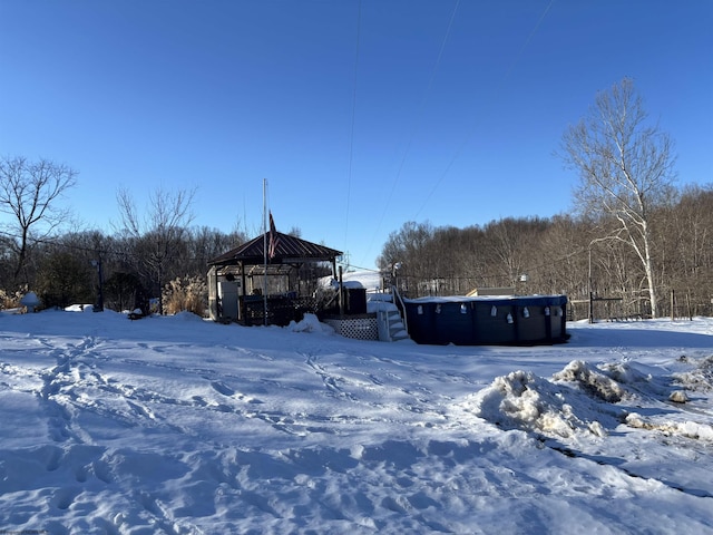 snowy yard featuring a gazebo