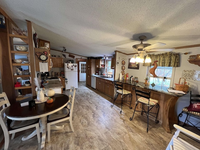 dining room with a textured ceiling and ceiling fan