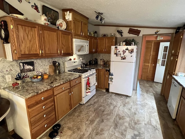 kitchen featuring ornamental molding, a textured ceiling, and white appliances