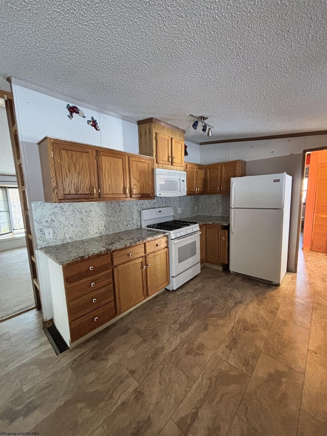 kitchen with white appliances, decorative backsplash, and a textured ceiling