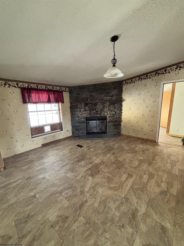 unfurnished living room with a textured ceiling and a fireplace